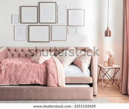 Comfortable pink bunk bed designed for girls with pillows in the living room. Interior design concept, blank wall picture frames mock-up
