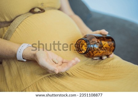 Prenatal Vitamins. Portrait Of Beautiful Smiling Pregnant Woman Holding Transparent Glass Jar With Pills, Taking Supplements For Healthy Pregnancy While Sitting On Couch At Home, Free Space Royalty-Free Stock Photo #2351108877