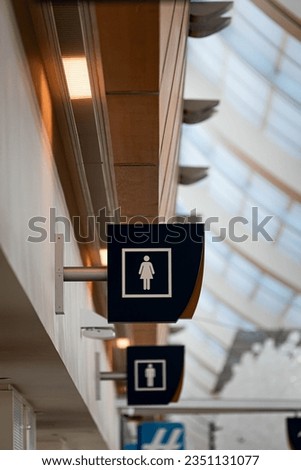 Information sign directing travelers to restrooms at San Jose International Airport, California