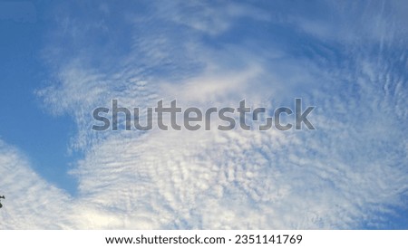 Weird clouds has a pastel blue color and wave-like patterns of white clouds