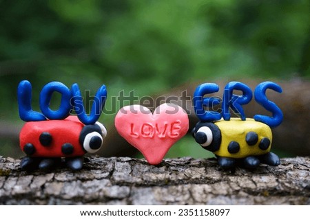 Two ladybugs and the inscription lovers. Romantic relationships. Couple. Valentine's Day. Royalty-Free Stock Photo #2351158097