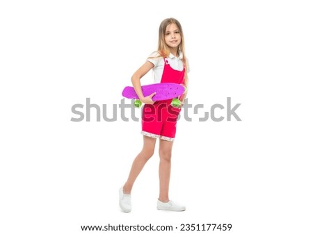 teen girl skateboarding in studio, full length. teen girl skateboarding on background.