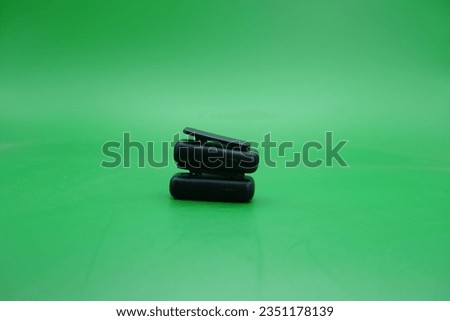 a pair of wireless mics over a green background. wireless mic that is usually used by content creators.
