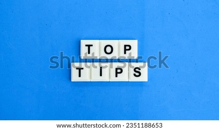 letters of the alphabet with the word top tips. the concept of finding or getting tips