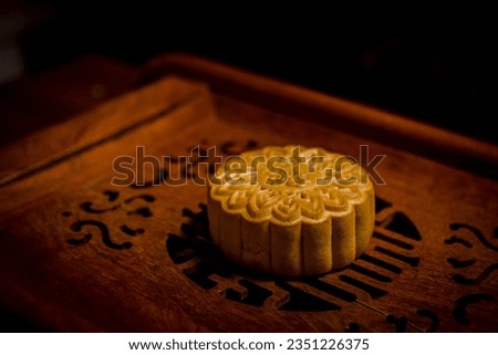 Round shaped Chinese traditional mooncakes on wooden background. Mid Autumn festival and Chinese traditional festival.