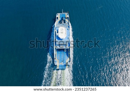 Ferry boat crossing the sea, carrying cars and passengers, deck of a boat carrying vehicles. Aerial view Royalty-Free Stock Photo #2351237265