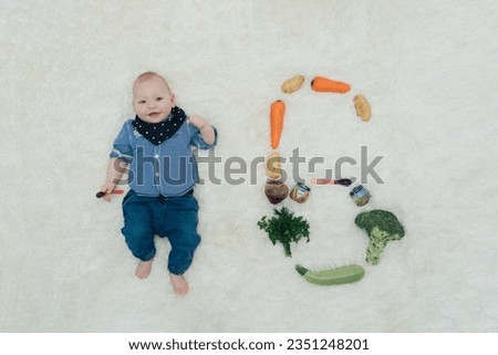 1  months old boy with number beside Royalty-Free Stock Photo #2351248201