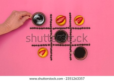 Caucasian Hand Coffee Tic Tac toe Game and Mini Pie