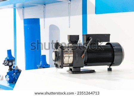 close up metal horizontal multistage centrifugal pump with electric motor for conveying drinking water or liquid in plumbing or beverage industrial or other application work Royalty-Free Stock Photo #2351264713