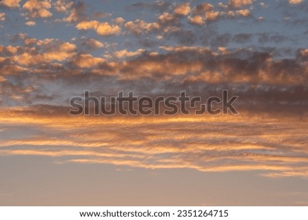 View of clouds at sunset with scattered colours and glowing colours
