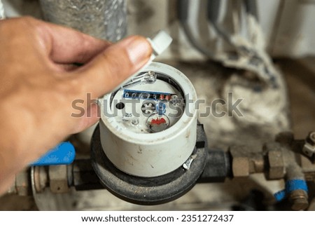 The water meter indicates how much water is consumed at home Royalty-Free Stock Photo #2351272437