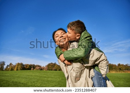 cute boy kissing cheek of mom, african american family, having fun together, love, bonding concept Royalty-Free Stock Photo #2351288407