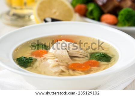 Chicken soup with vegetables and Italian pasta orzo