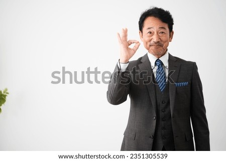 Business image of a middle man who makes an okay sign