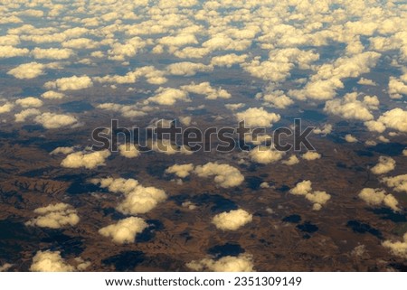 aerial view from window of airplane , aerial view of earth with clouds and shadows on the earth 