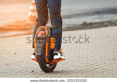 Electric unicycle. Man rides on electric mono wheel down the city street. Man cycling on monowheel in protective gear. Boy rides on single wheel
 Royalty-Free Stock Photo #2351315355