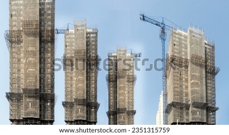Double exposure creative hologram of an unfinished supertall building. Describe China's real estate crash, bubble, financial turmoil and China's Lehman storm Royalty-Free Stock Photo #2351315759