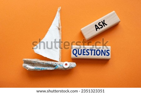 Ask Questions symbol. Wooden blocks with words Ask Questions. Beautiful orange background with boat. Business and Ask Questions concept. Copy space.