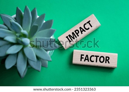 Impact Factor symbol. Wooden blocks with words Impact Factor. Beautiful green background with succulent plant. Business and Impact Factor concept. Copy space.