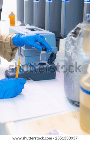Measuring water's turbidity level in the lab Royalty-Free Stock Photo #2351330937