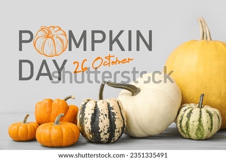 Different pumpkins on light background. Greeting card for National Pumpkin Day