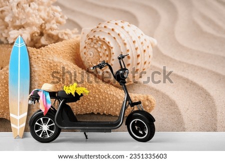 Electric scooter with wooden surfboard near wall with printed sea shell and starfish