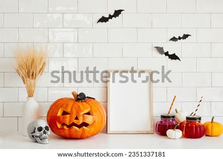 Picture frame template, Halloween decorations, Jack o lantern, pumpkins, skull, drinks, bats on tile wall in Scandinavian style home interior