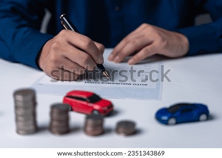 Signing a car purchase or lease agreement. Car loan and insurance concept.