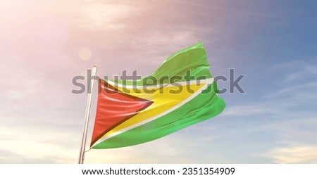 Guyana national flag waving in beautiful sky.