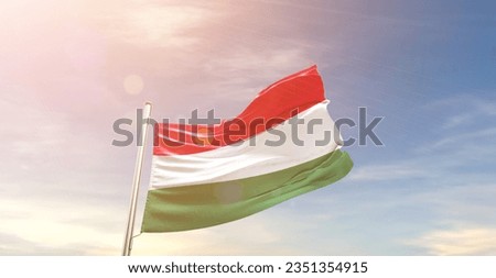 Hungary national flag waving in beautiful sky.