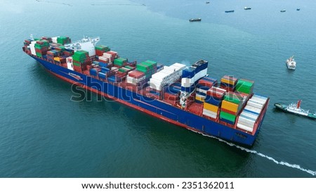 Aerial side view of  cargo container ship carrying container from custom container depot go to ocean concept freight shipping by ship service on blue sky .Freight Forwarding Service