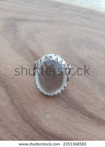 selective focus photo of Ring stones isolated on wooden table 
