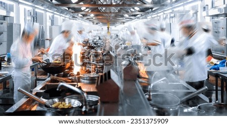 Motion chefs working in Chinese restaurant kitchen