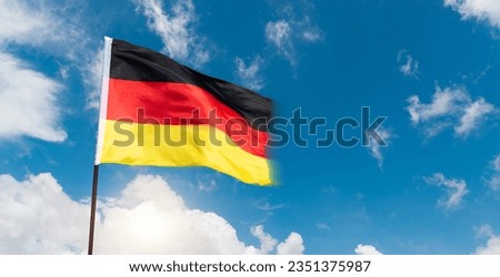 German flag waving against blue sky background