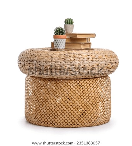 Wicker pouf with cacti and books isolated on white background Royalty-Free Stock Photo #2351383057