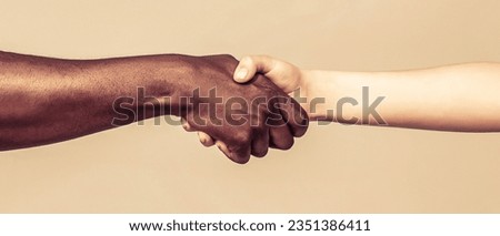 African and caucasian hands. Giving a helping hand to another. Woman and african woman hand. Helping hand, Rescue, multiathnic people. Royalty-Free Stock Photo #2351386411