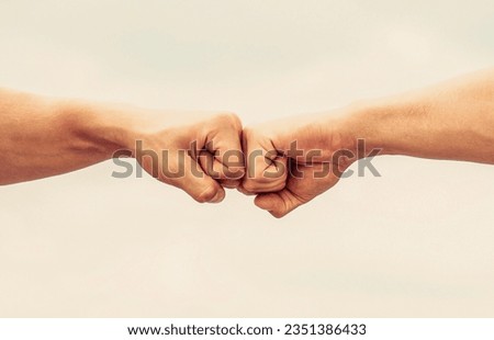 Teamwork and friendship. Partnership concept. Man giving fist bump. Bumping fists together. Fist Bump. Clash of two fists. Concept of confrontation, competition. Royalty-Free Stock Photo #2351386433