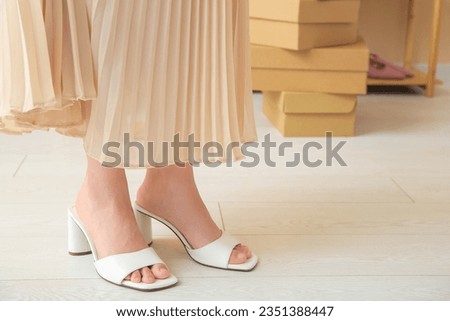 Woman in stylish sandals in store, closeup Royalty-Free Stock Photo #2351388447