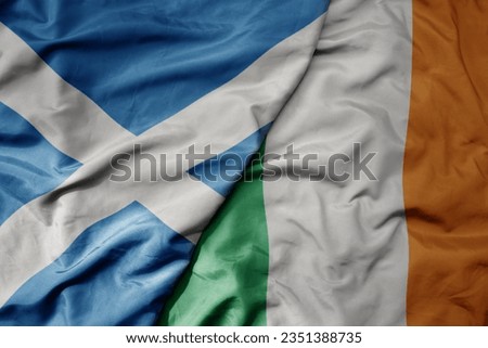 big waving national colorful flag of scotland and national flag of ireland . macro