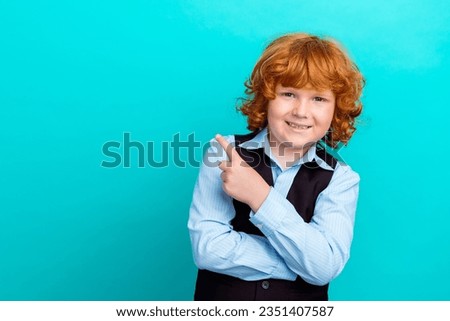 Photo portrait of adorable foxy wavy hair boy point empty space dressed stylish school uniform outfit isolated on cyan color background