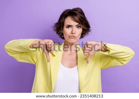 Photo of grimace business lady grimacing thumbs up decline candidate dissatisfied bad rate no effective isolated on violet color background