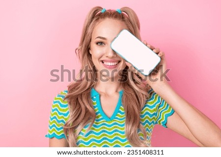 Photo of lovely positive girl wavy hairdo wear stylish blouse showing screen website empty space isolated on pink color background