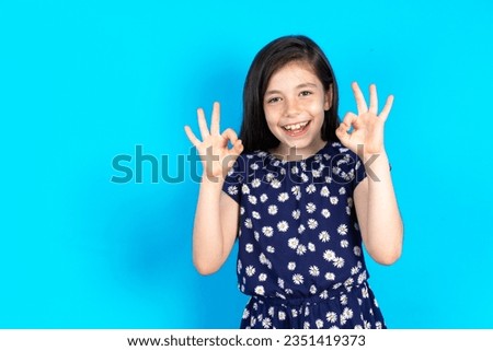 caucasian kid girl wearing floral dress looking sleepy and tired, exhausted for fatigue and hangover, lazy eyes in the morning. Royalty-Free Stock Photo #2351419373