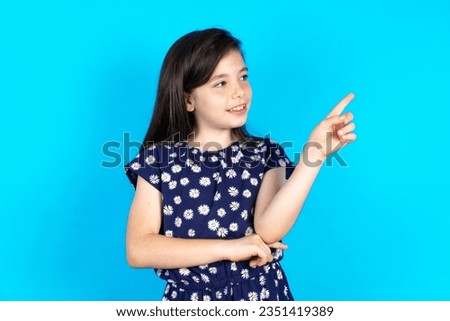 Photo of attractive caucasian kid girl wearing floral dress direct finger empty space cheap dentistry