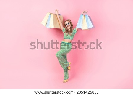 Full body photo of pretty young girl hold sales commercial shopping wear trendy green print outfit isolated on pink color background
