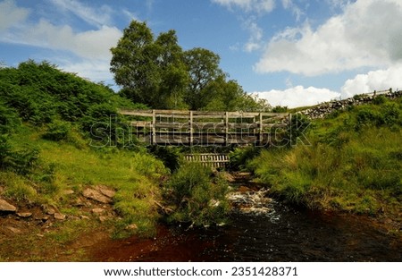 wooden Bridge over a small river in the Scottish Highlands Royalty-Free Stock Photo #2351428371