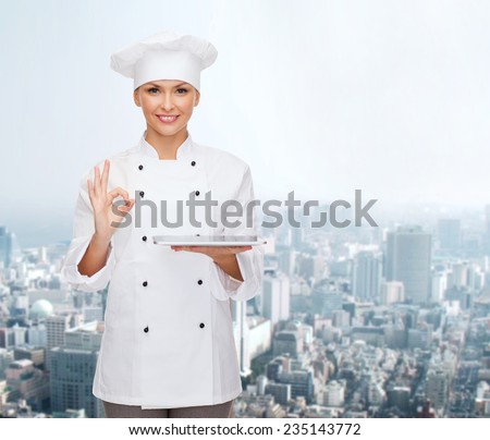cooking, technology and people concept - smiling female chef, cook or baker with tablet pc computer showing ok gesture over city background