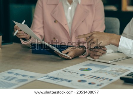 Asian man and woman meeting Asian Business Consultants to analyze and discuss financial report situation with digital tablet in conference room. investment advisor, collaboration concept