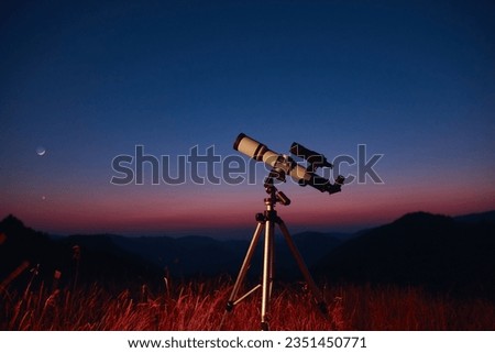 Astronomical telescope for observing stars, planets, Moon, celestial objects in the sky. Royalty-Free Stock Photo #2351450771