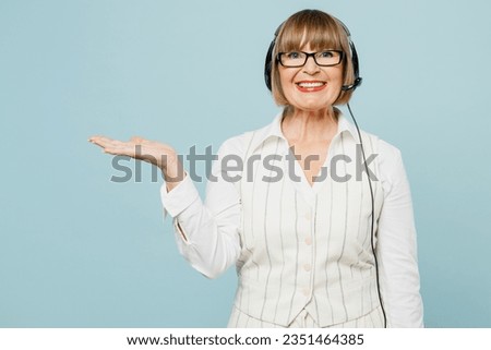 Employee operator business woman in set microphone headset for helpline assistance wear white classic suit glasses formal clothes working at call center isolated on plain pastel light blue background